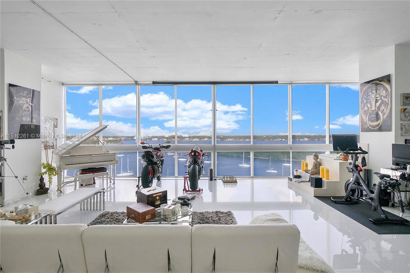 Unique fully furnished corner unit loft at the contemporary Space 1, a waterfront building, with panoramic views of Biscayne Bay and Downtown Miami Skyline in North Bay Village, designed by ...