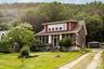 Driveway view and 2-car garage. Total parking for 7 cars on property.