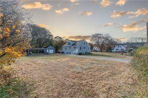 Beautifully renovated cape on an oversized lot with multiple outbuildings !