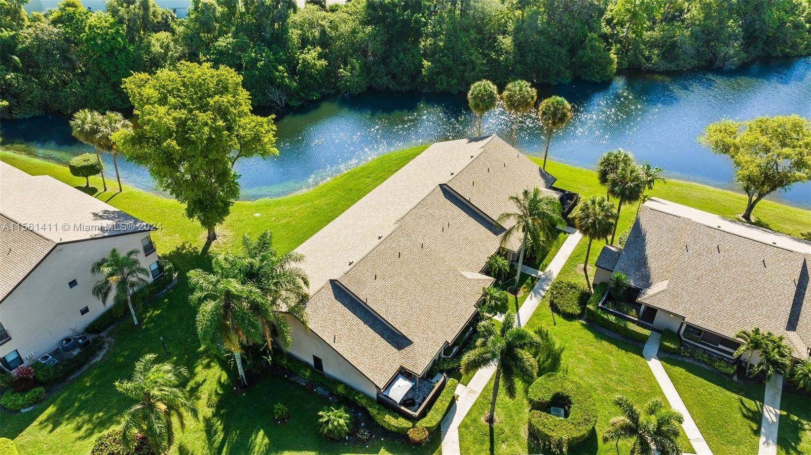 Gorgeous Upgraded 2 Bed 2 Bath Corner Villa boasting an enclosed air conditioned Florida room overlooking serene lake garden view.