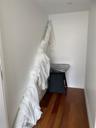 Bedroom featuring dark wood-style flooring and baseboards