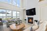 Living room with a high ceiling and fireplace