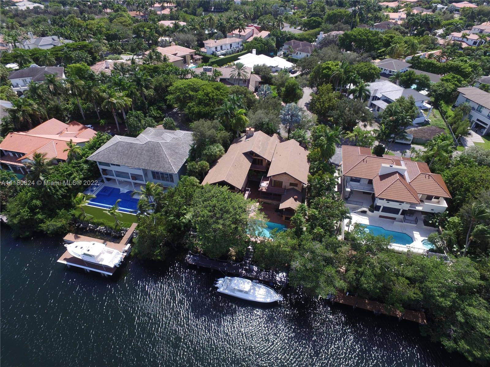 Yachtsman's dream home with 100 feet of waterfront, complete with wood dock and NO bridge to bay.