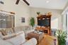 Living area with ceiling fan, wood finished floors, high vaulted ceiling, and recessed lighting