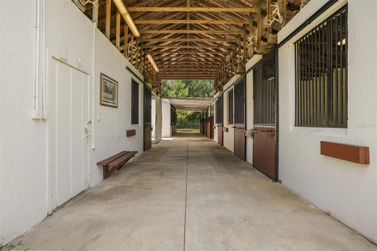 Center-aisle barn featuring hot water, updated electrical, and convenient access to all stalls