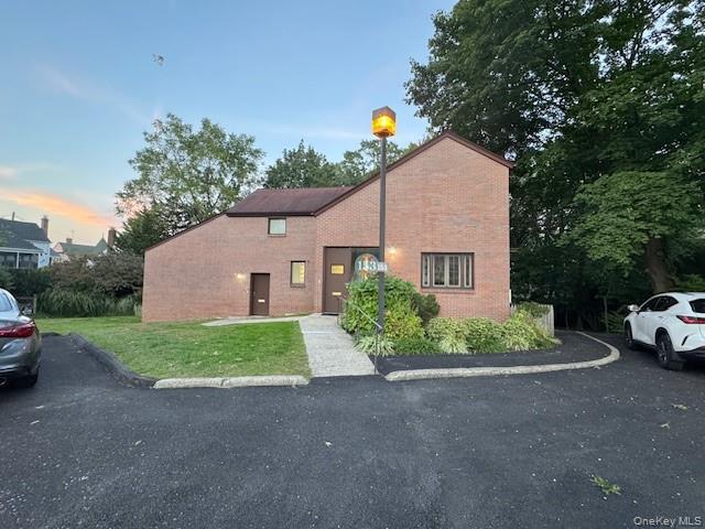 Brick exterior with peak roofline offering character and curb appeal.