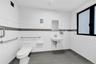 Half bathroom with tile patterned floors and tile walls