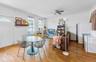 Dining area with hardwood / wood-style floors, crown molding, and ceiling fan