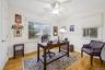 Home office with a ceiling fan and light wood finished floors