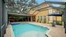 Beautiful caged pool area with ciovered lanai
