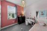 Secondary bedroom with soft color palette and upgraded chandelier.