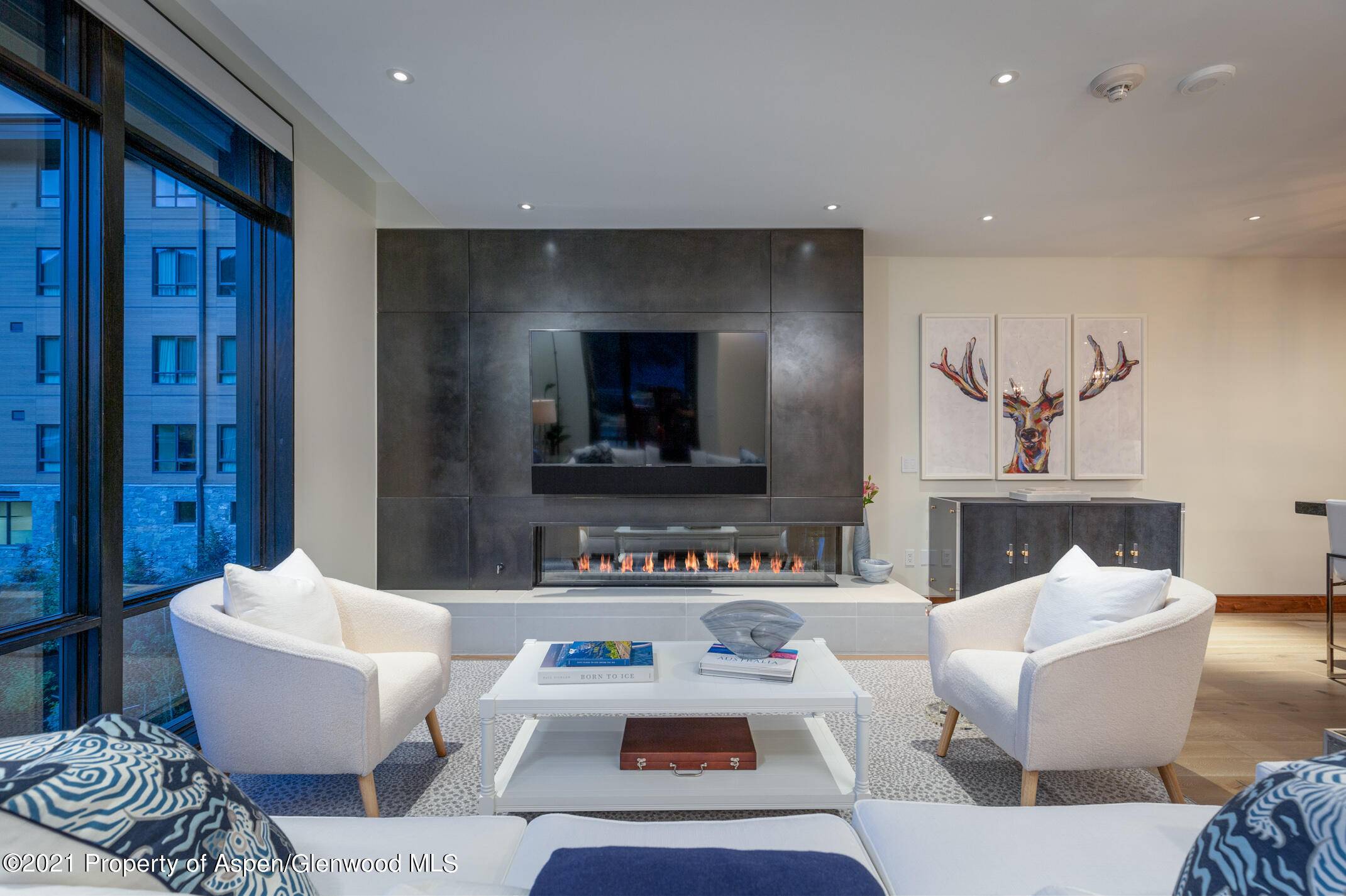 Luxurious two bedroom One Snowmass Residence with floor to ceiling windows, high end finishes, and meticulously designed furnishings.