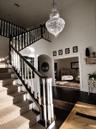 Walk into an Elegant Foyer with New Large Crystal Chandleir, Custom Stair carpet and New Hardwoods and New Front Foor