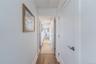 Corridor with baseboards and wood finished floors