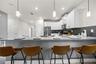 open concept kitchen with stainless steel appliances and counter hieght seating