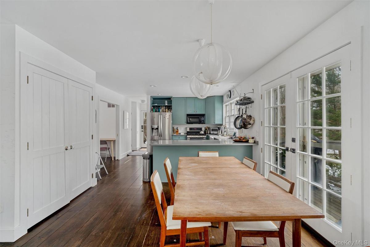 Dining space featuring french doors and dark wood-style floors