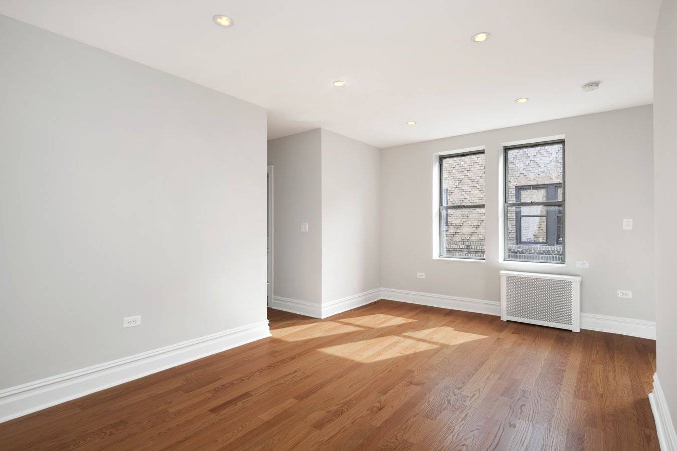 Modern, gut renovated, one bedroom, one bath apartment featuring new oak hardwood floors throughout, a spacious living room, windowed kitchen with Quartz counter tops, beautiful glass tiled backsplash, and stainless ...