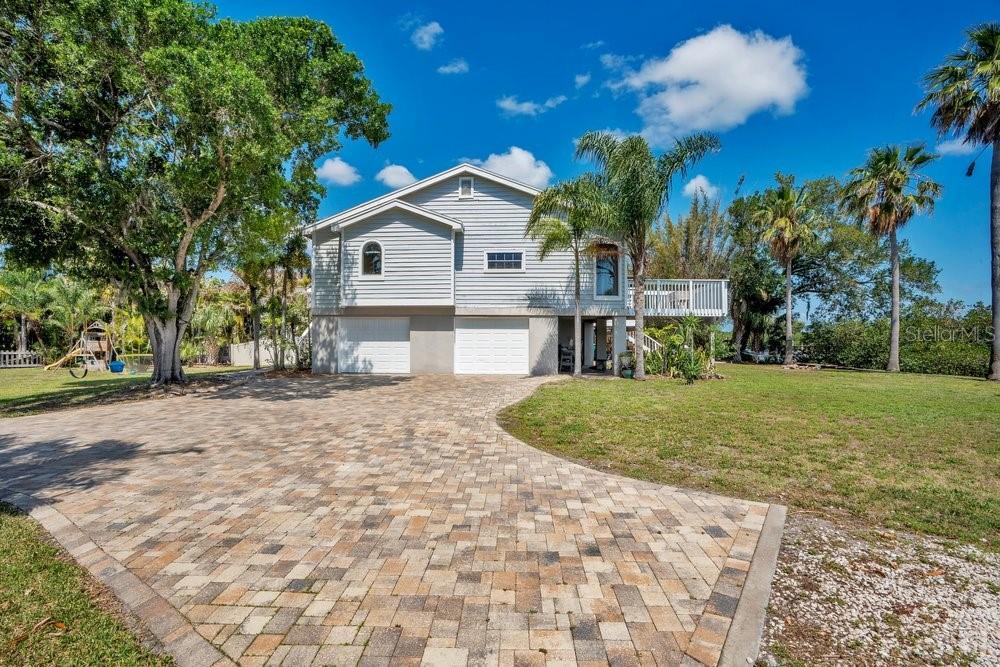 Elevated living space stayed dry during recent storms, paver driveway allows for plenty of parking and yard has room for pool and extra space for boat