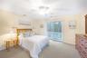 Bedroom featuring light carpet, access to exterior, and ceiling fan