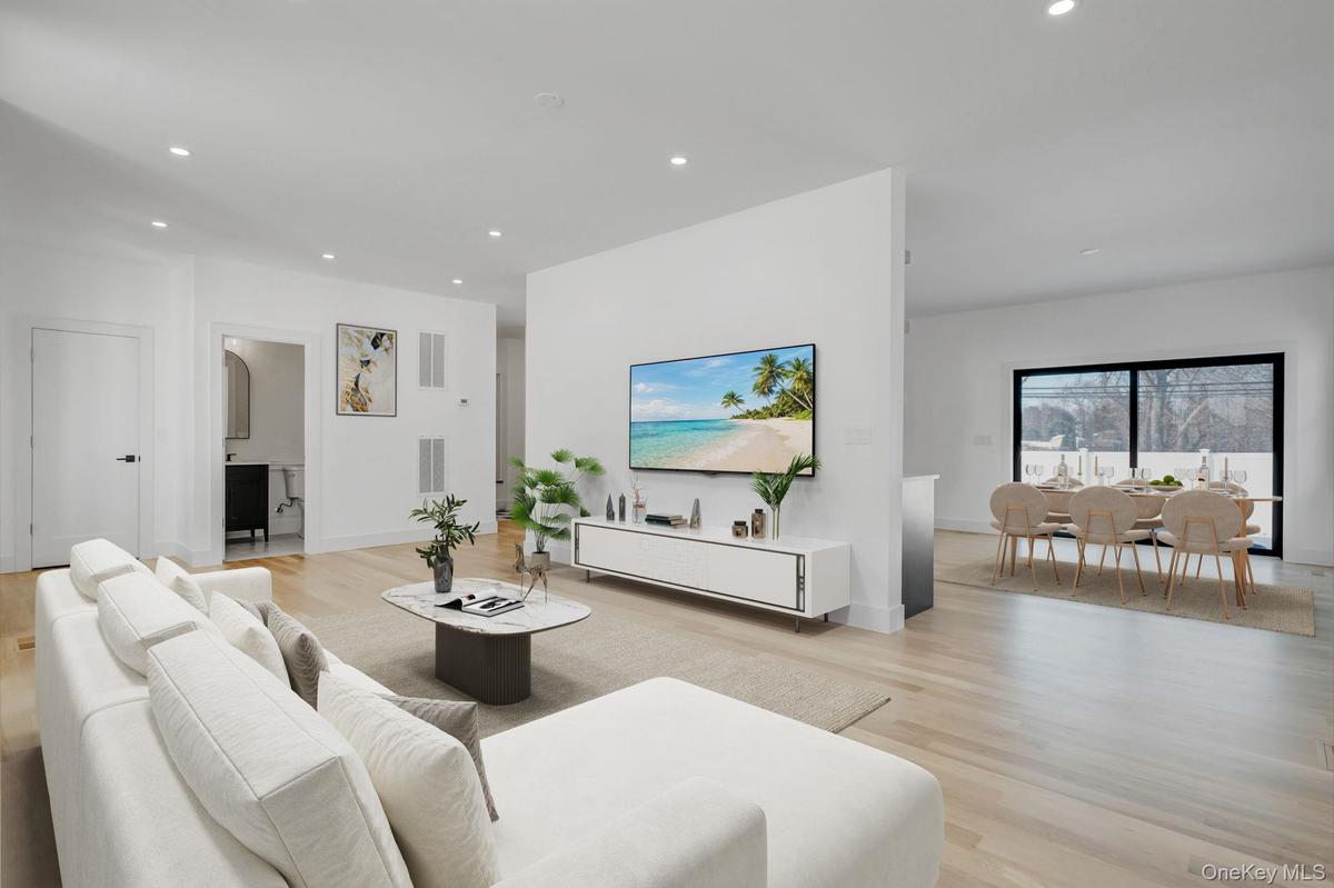 Spacious and open living area filled with natural sunlight from oversized windows, designed for both everyday comfort and entertaining.