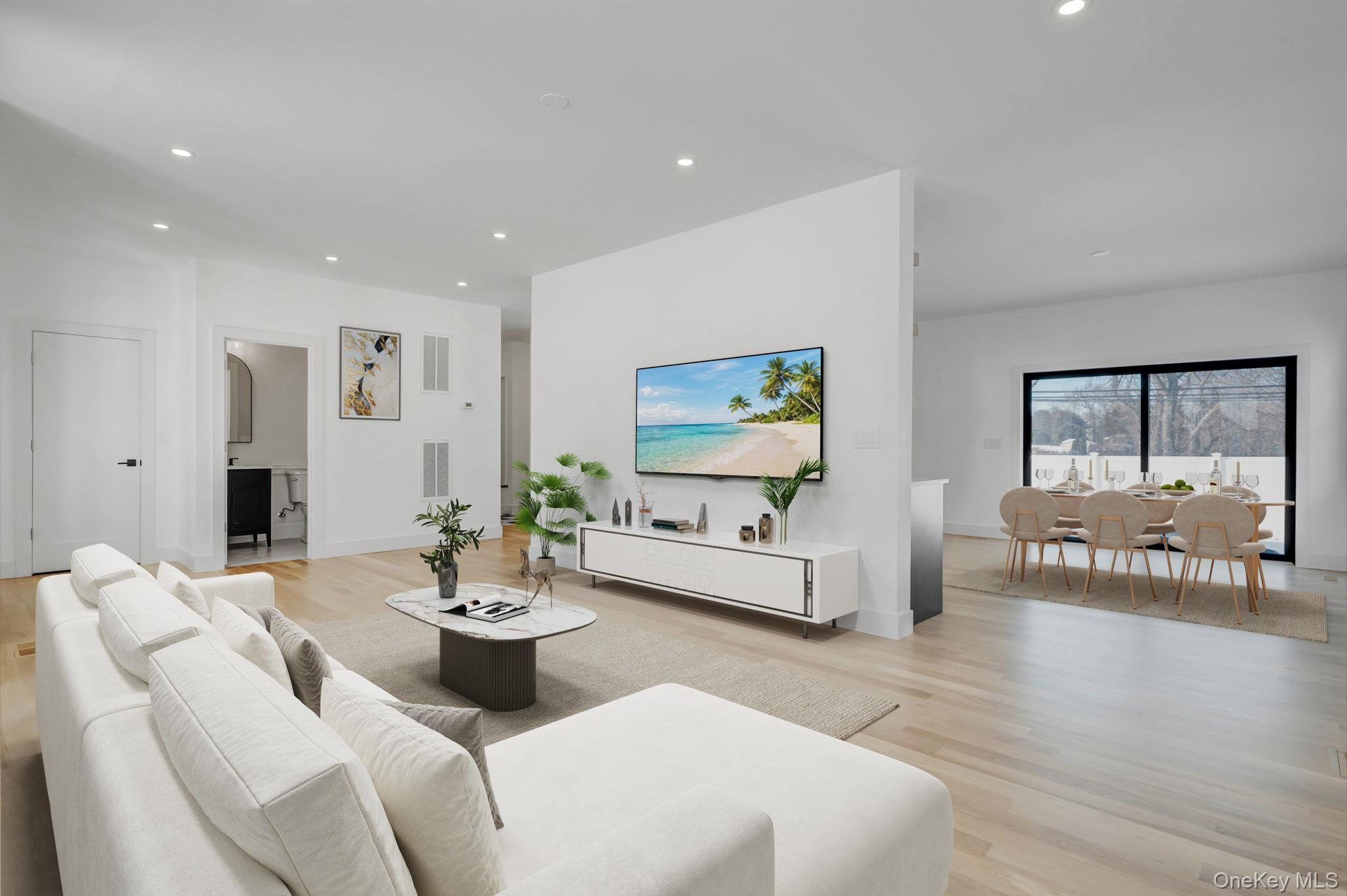Spacious and open living area filled with natural sunlight from oversized windows, designed for both everyday comfort and entertaining.
