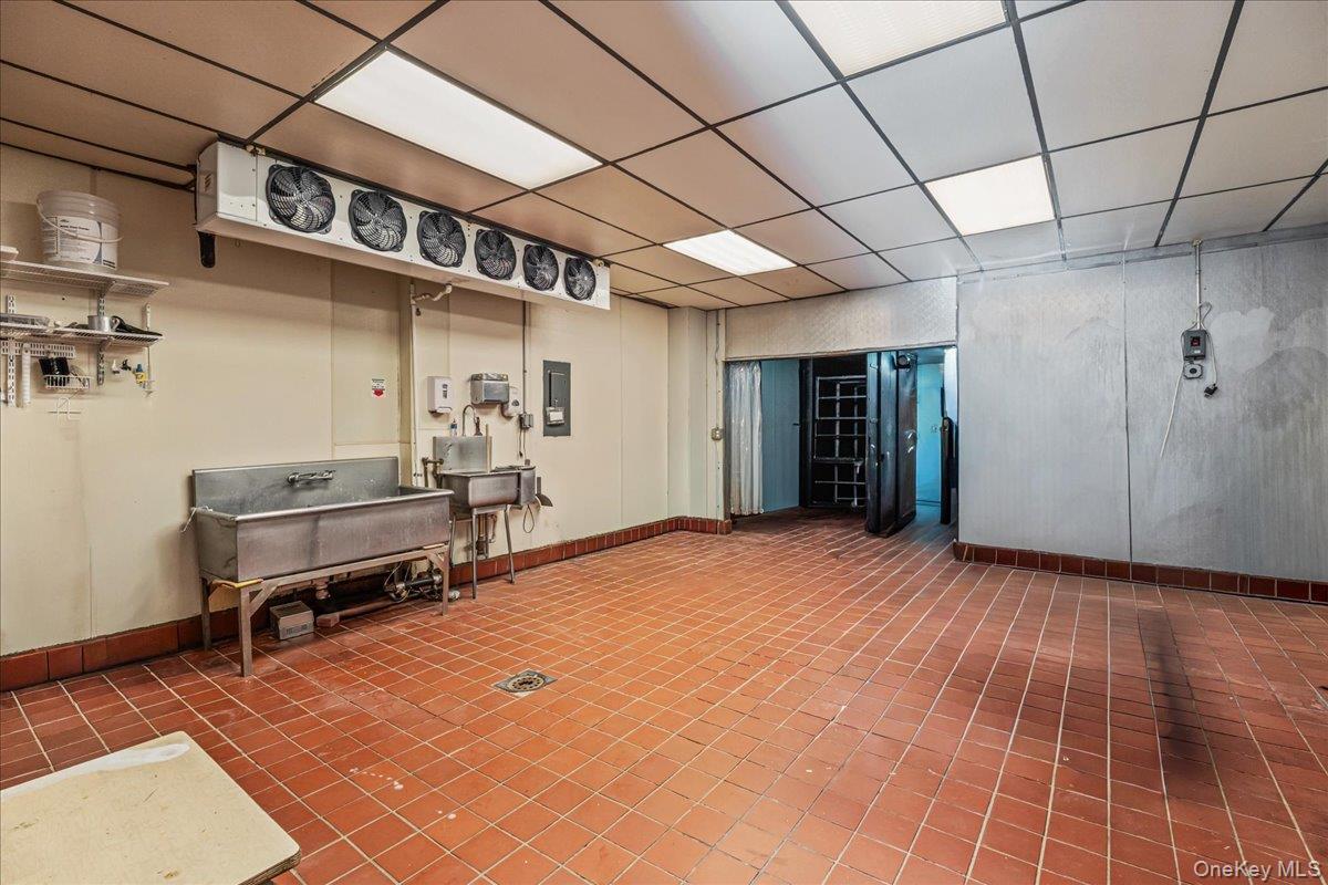 Miscellaneous room with a paneled ceiling and electric panel
