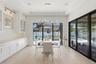 Dining area with custom cabinetry and designer lighting