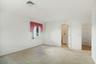 Primary bedroom with a view to the ensuite bath and walk-in closet