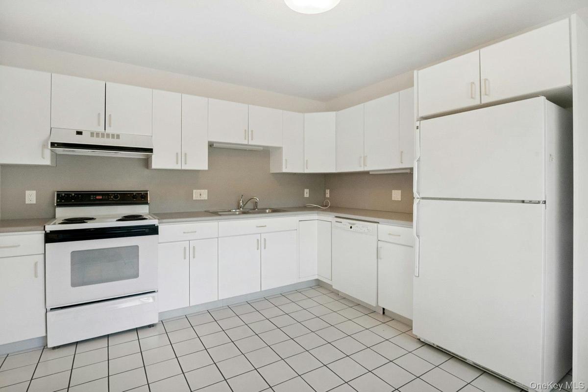 Another view of the kitchen showing ample counter space.To the far left of the oven, is pantry