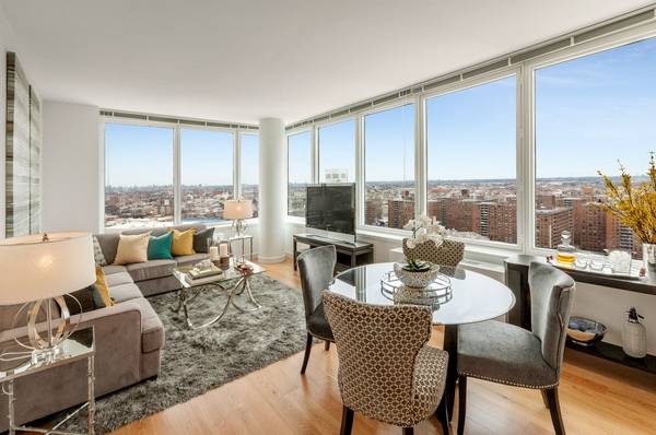 Stunning corner to bedroom with walls of glass showcasing Manhattan skyline views.