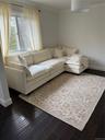 Living area with baseboards, dark wood-type flooring, and ornamental molding