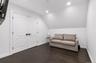 Living area featuring recessed lighting, dark wood-style floors, and lofted ceiling
