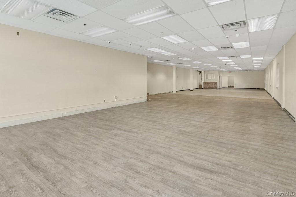 Spare room with light wood-style floors and a paneled ceiling
