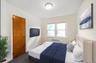 Bedroom featuring carpet and radiator heating unit