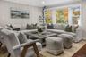 Bright and comfortable living room showcasing timeless updates and a peaceful view of the tree-lined property.