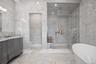 Bathroom featuring tile walls, double vanity, a freestanding tub, a shower stall, and marble finish floors