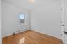 Empty room featuring a baseboard radiator and light wood-style floors