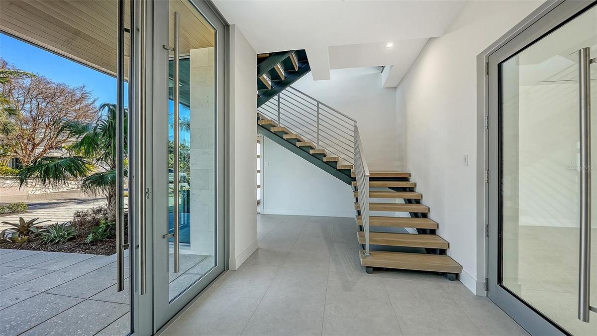Floating steel staircase with handmade white oak treads