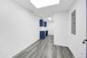 Spare room featuring electric panel and light wood-type flooring