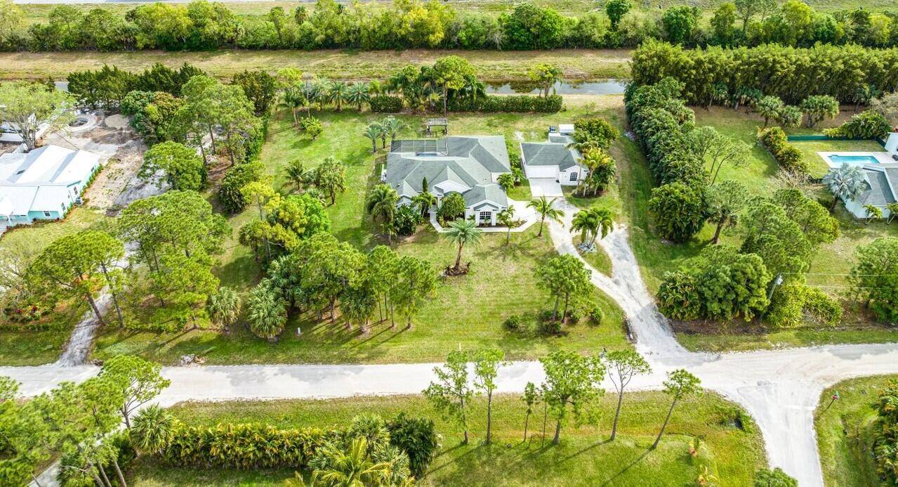 Welcome to this exquisite CBS pool home with a separate guest house nestled in the prestigious Palm Beach Country Estates !