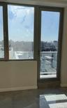 Doorway with a view of city and concrete flooring