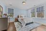 Bedroom featuring dark wood-type flooring, ornamental molding, and recessed lighting.
