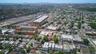 Aerial perspective showcasing the urban landscape with numerous residential structures and commercial buildings