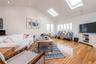 Vaulted ceiling great room featuring recessed lighting, skylights, wood-finish flooring, and multiple windows