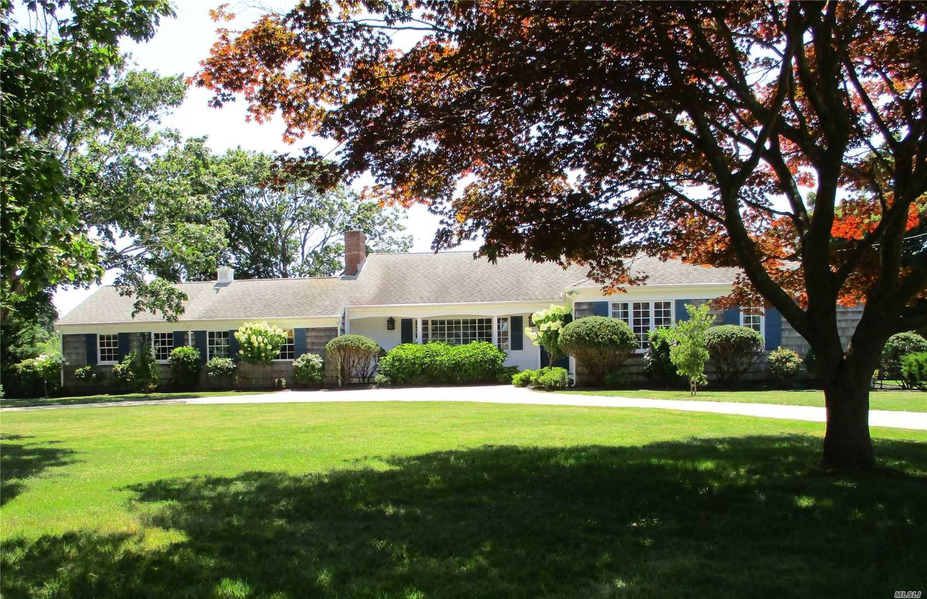 QUOGUE ESTATE SECTION OPPORTUNITY Perfectly situated on one of the last available parcels in the heart of Quogue's estate section, this bright mid century cottage is the perfect summer getaway.
