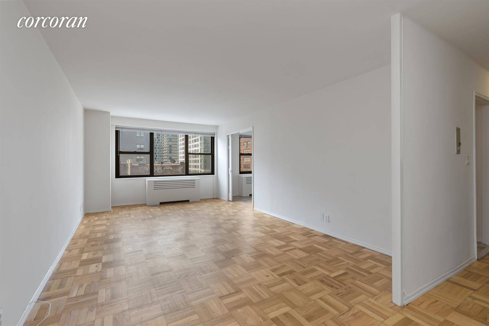 Enjoy all day sun and open views from this wonderful SW corner converted two bedroom apartment with hardwood floors throughout, and windows in all rooms !