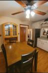 Dining space with light wood finished floors and ceiling fan