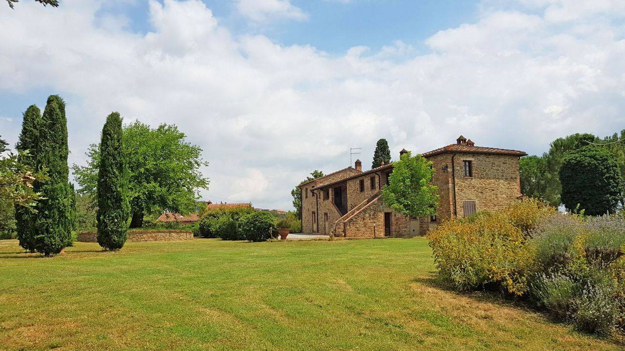 Property consisting of stone country house divided into 3 flats, guest house, swimming pool and 2-hectare park for sale in Lucignano, Tuscany.
