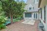 Perfectly positioned just off the kitchen and family room, the spacious brick patio invites seamless indoor-outdoor living with tranquil views of the