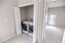 Ideal laundry location by primary suite.